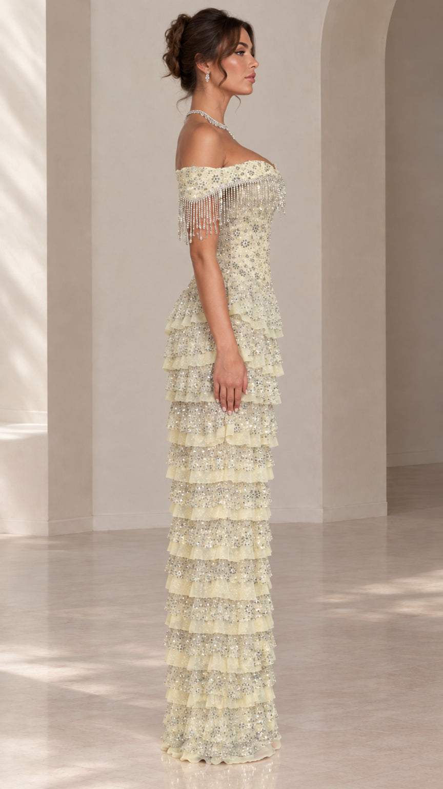 Side profile view of light yellow tiered sequin maxi formal dress