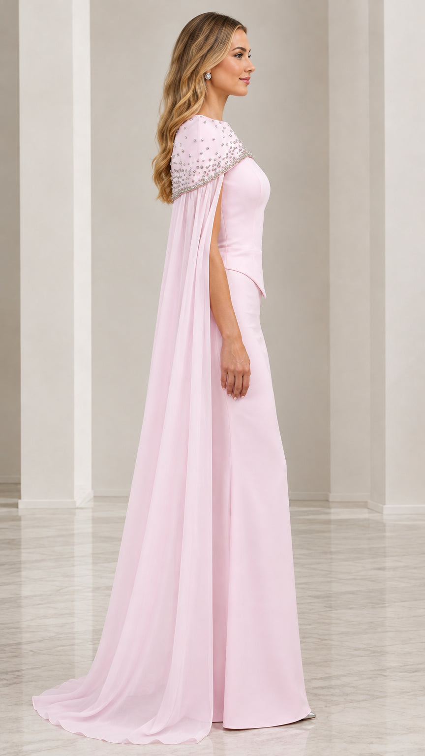 Side view of blush pink floor length gown showcasing flowy cape drape