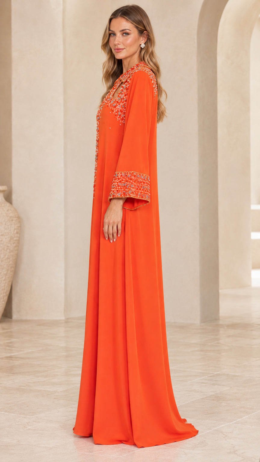 Side profile view of woman wearing orange long sleeve embellished kaftan dress