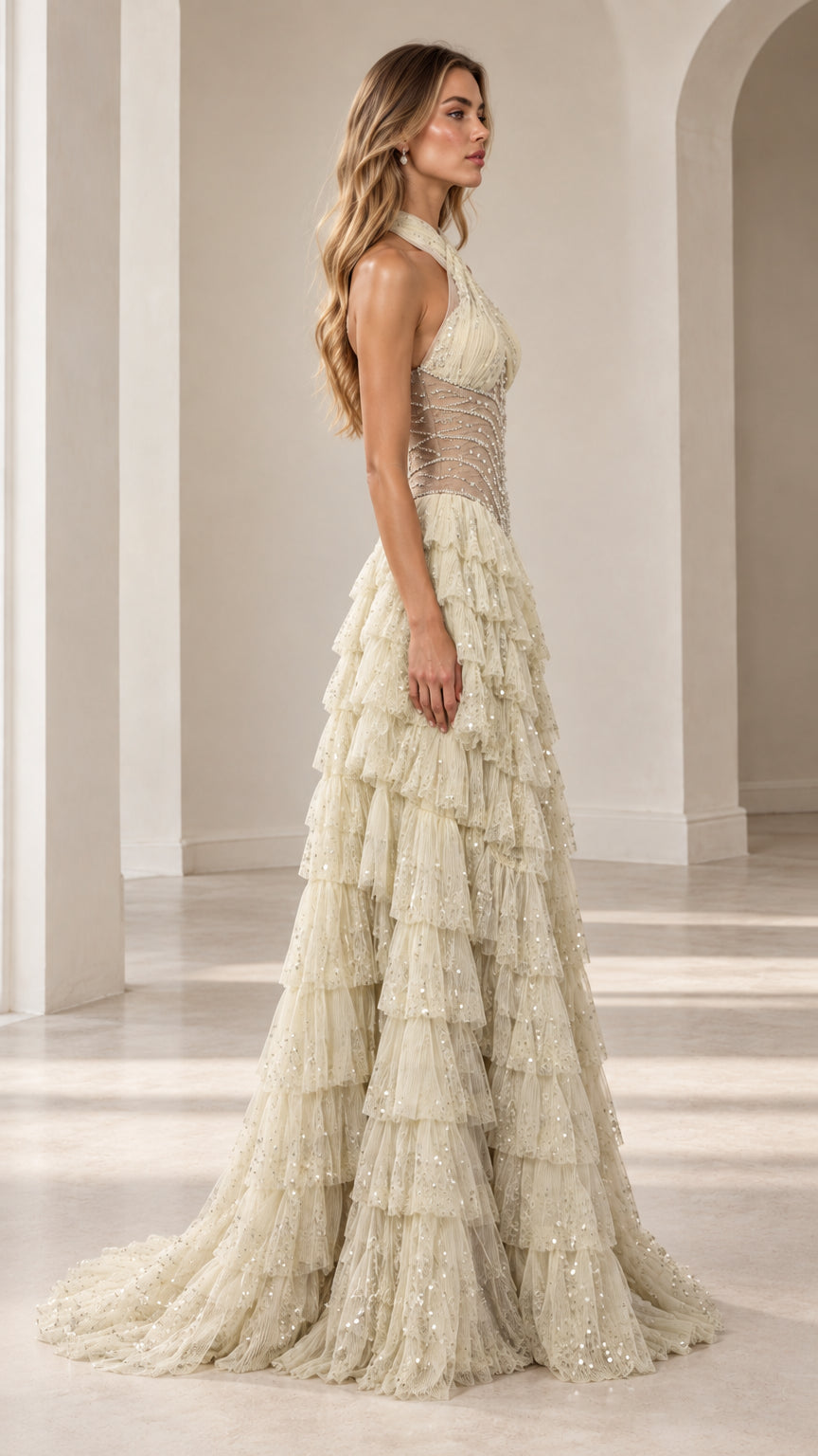 Side profile view of Champagne halter tiered sequin formal gown