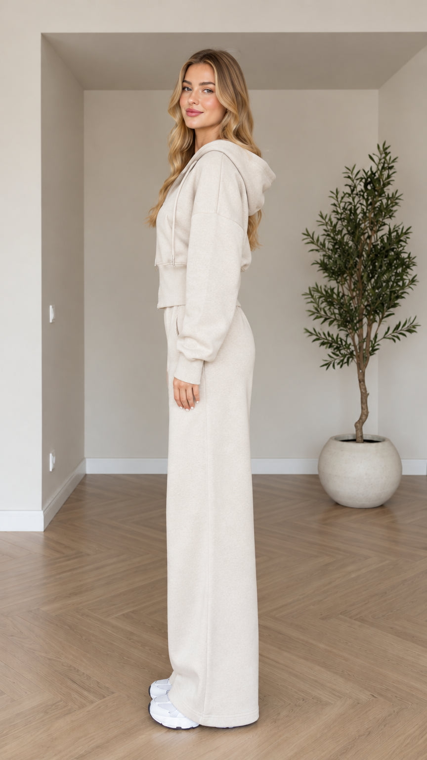 Side profile view of woman modeling beige two-piece loungewear set