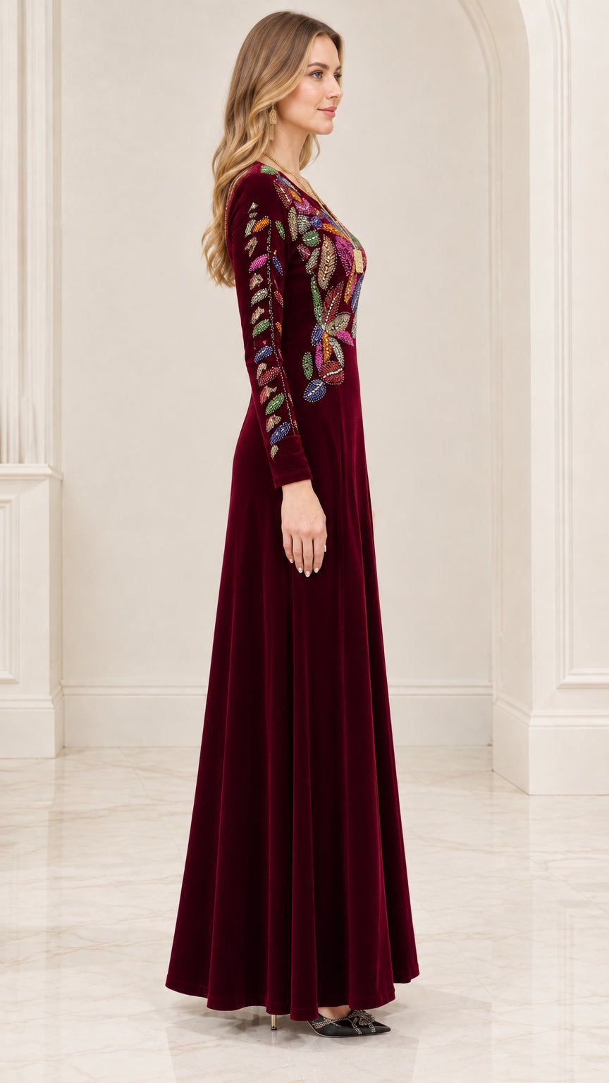 Side profile view of burgundy velvet long sleeve formal dress