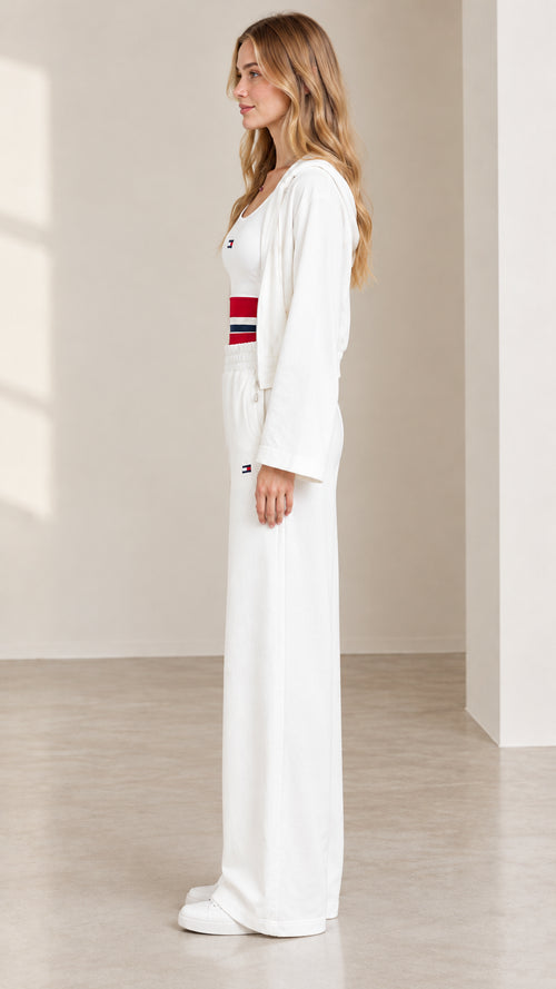 Side profile of women's white 3-piece loungewear set showing loose leg silhouette