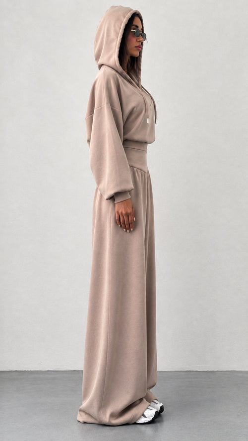 Side profile of woman wearing taupe wide leg two piece loungewear set