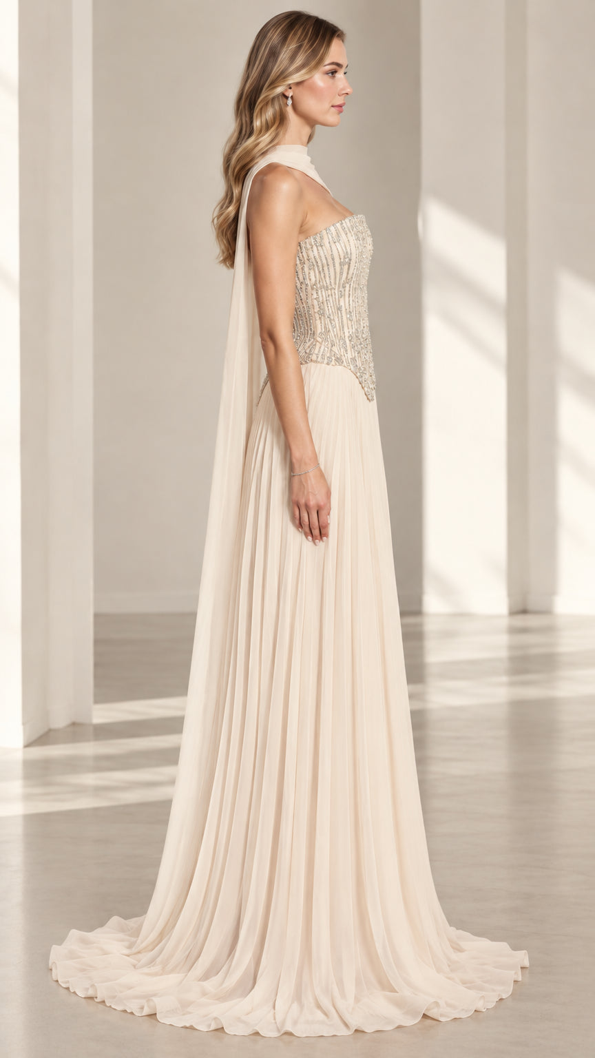 Side profile of model wearing champagne pleated chiffon formal gown with draped neck scarf