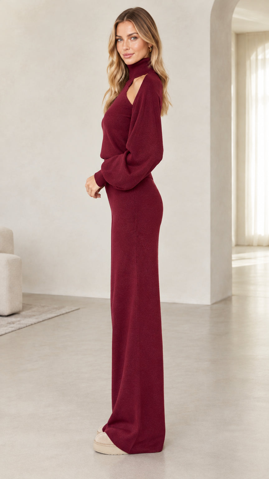 Side view of woman wearing burgundy knit two-piece sweater and wide-leg lounge pants