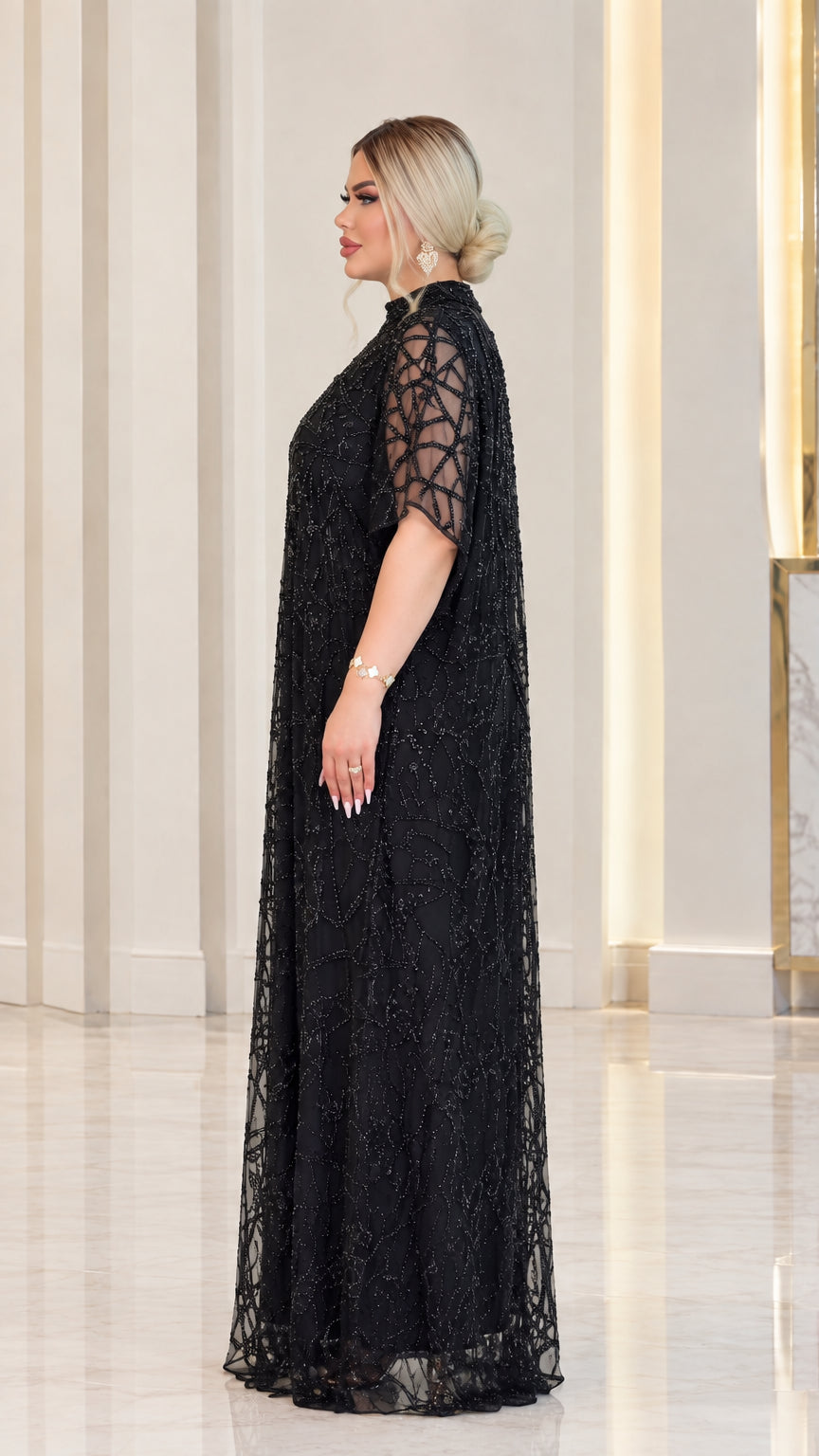 Side profile of black sequin embellished mesh formal maxi gown