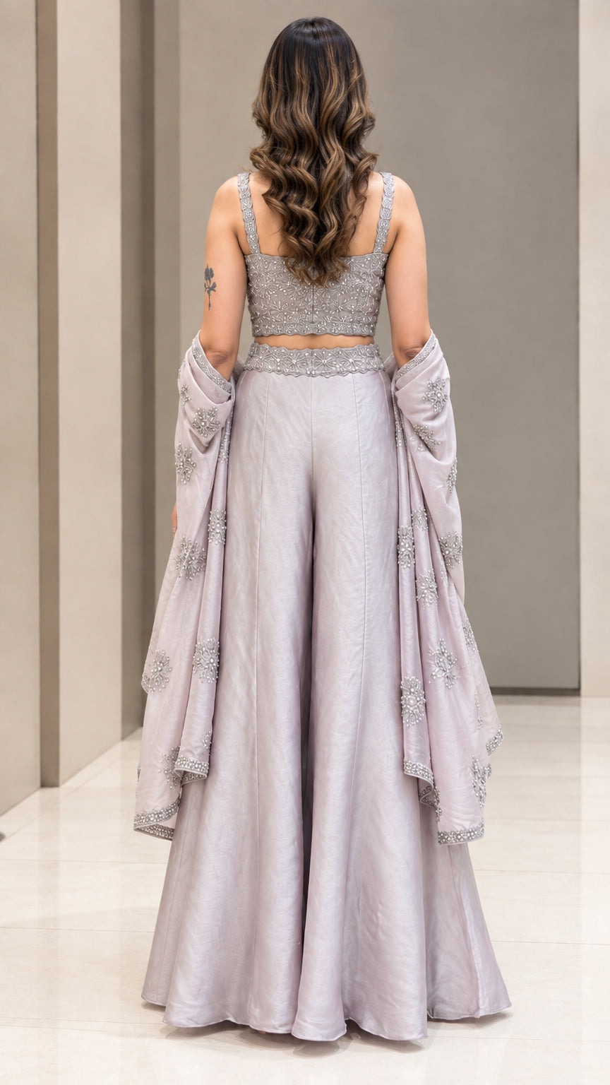 Back full-length view of woman showing fitted back crop top and palazzo trousers in Silver Grey