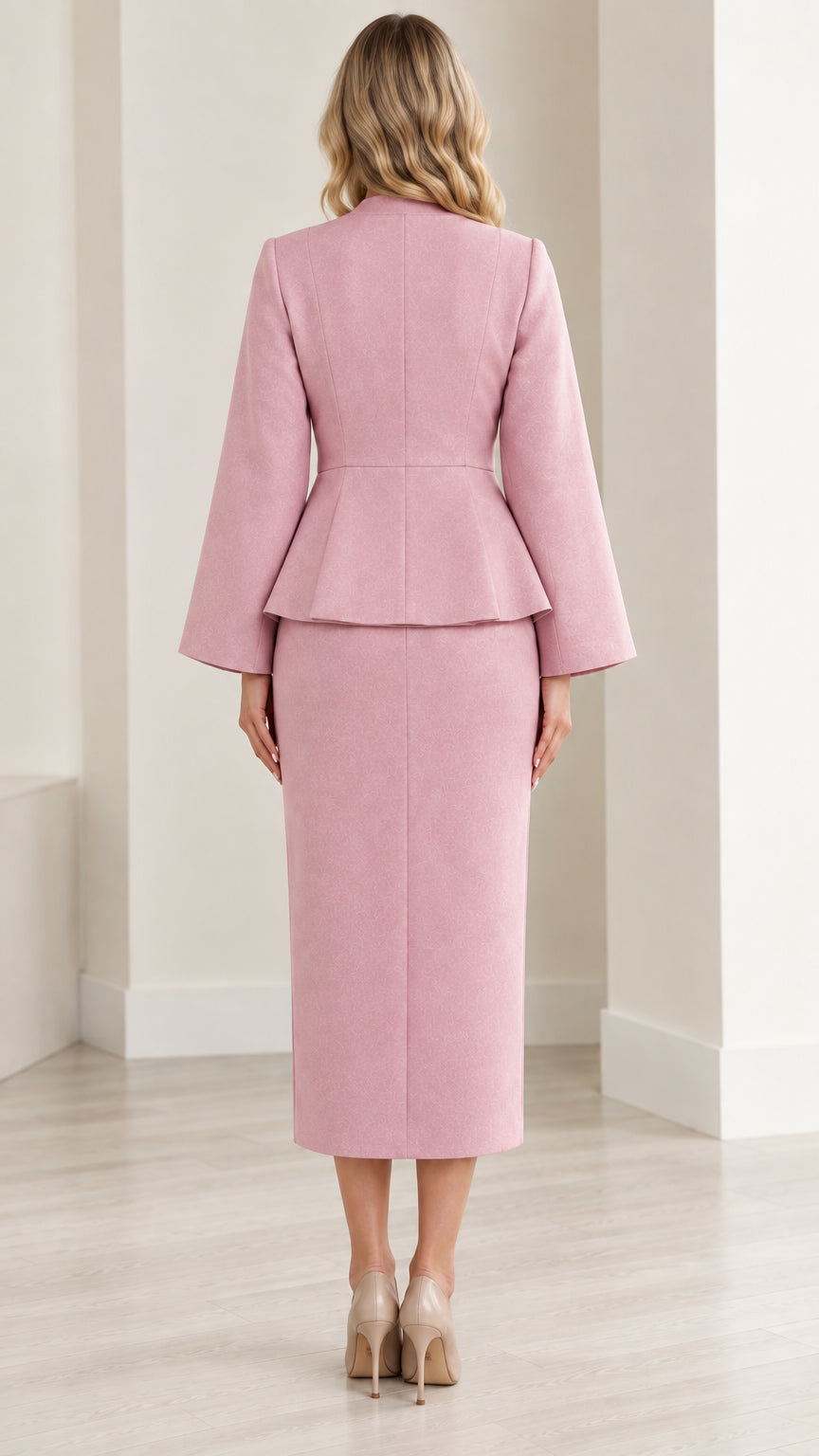 Back view of dusty pink tailored peplum top and slit midi skirt set