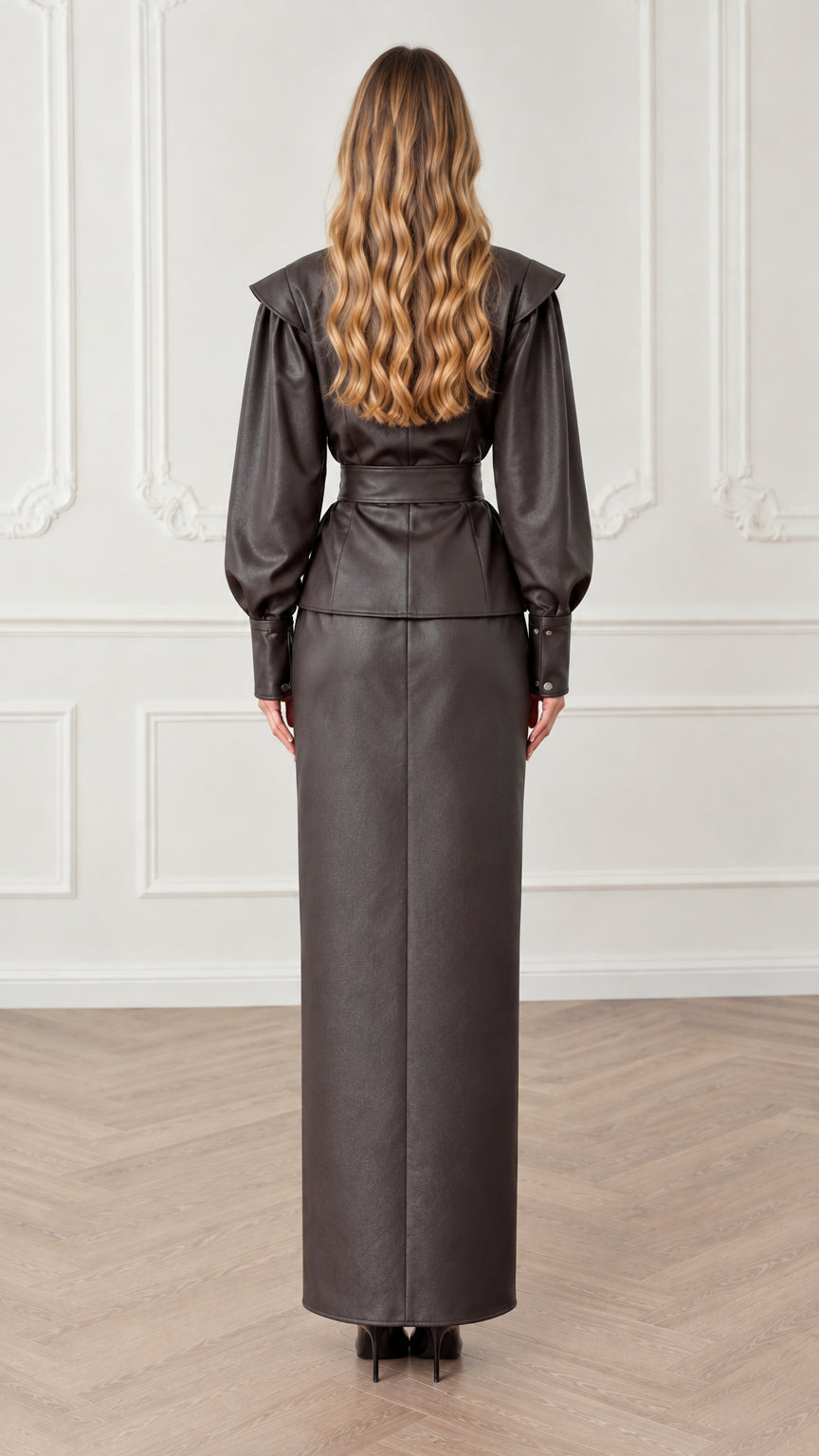 Back view of dark brown faux leather wrap top with tie belt and maxi skirt