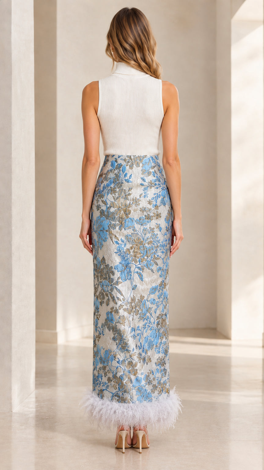Back view of model showcasing the Light Blue jacquard maxi dress with feather hem