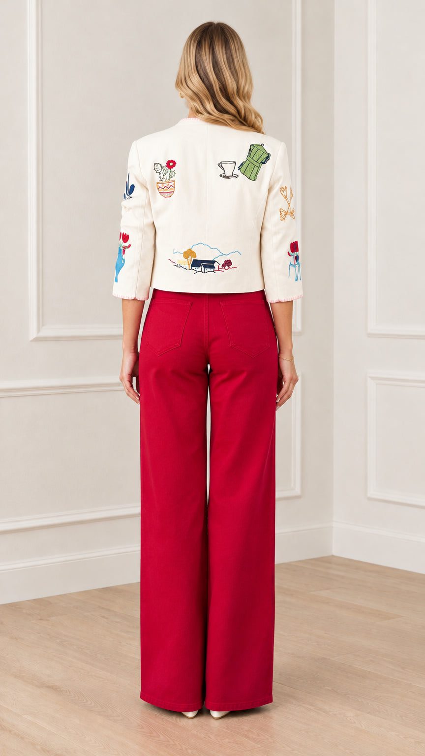 Back view of cream cropped jacket highlighting embroidered landscape and teapot details