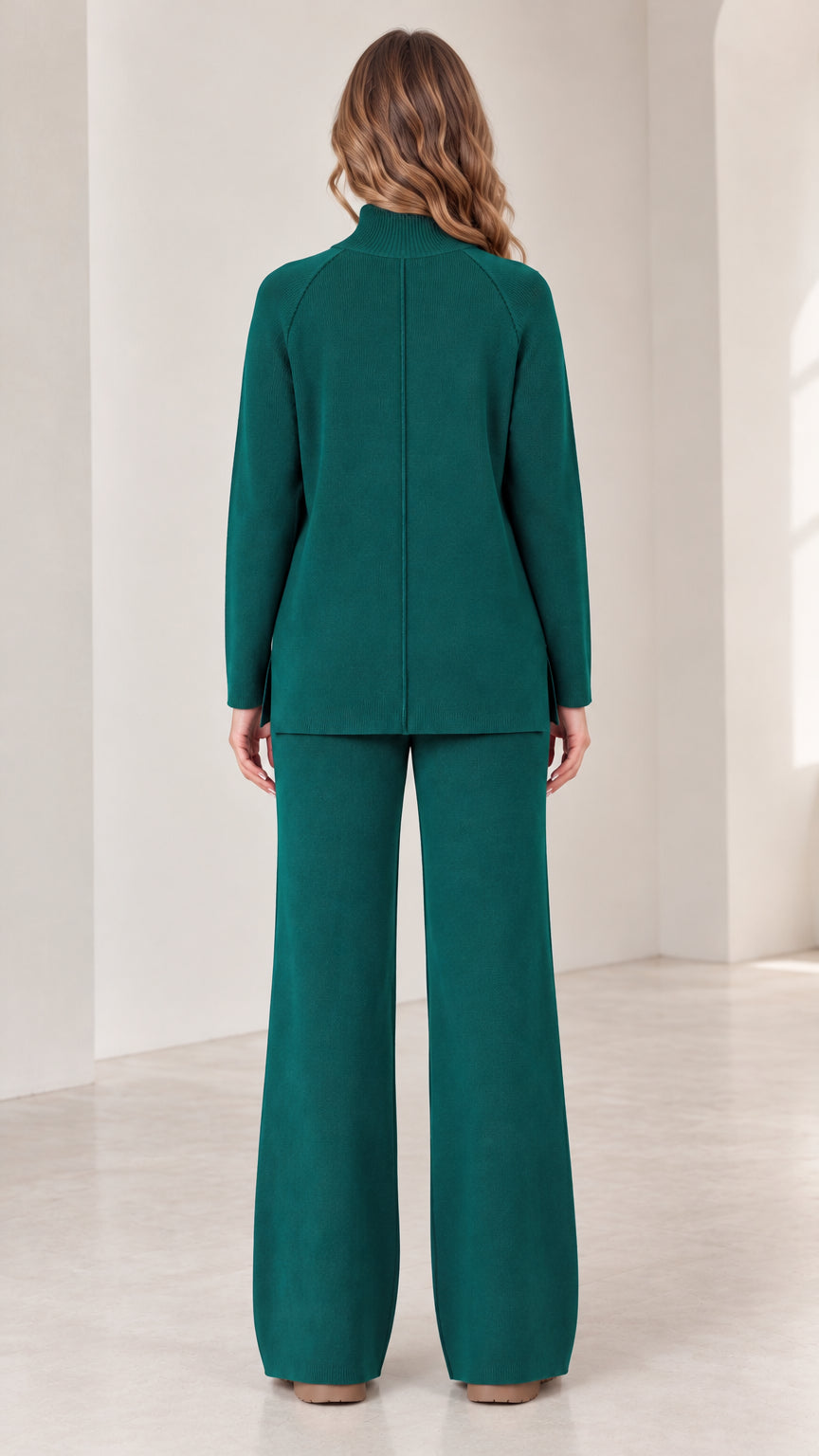 Back view of model wearing Forest Green mock neck knit pullover and wide leg trousers