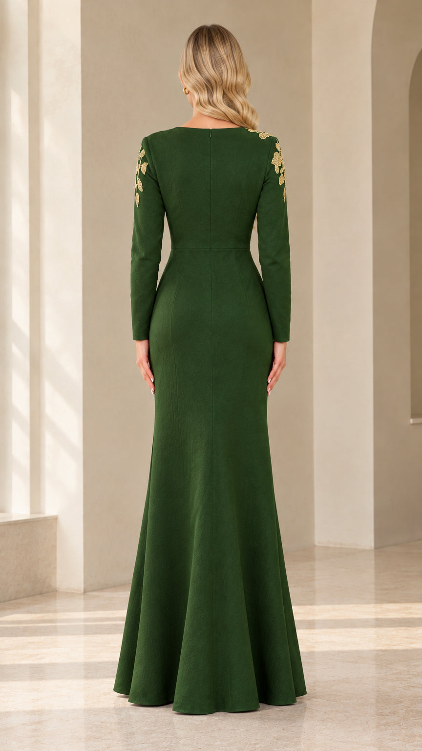 Back view of emerald green evening gown showing rear fit and sleeve embroidery