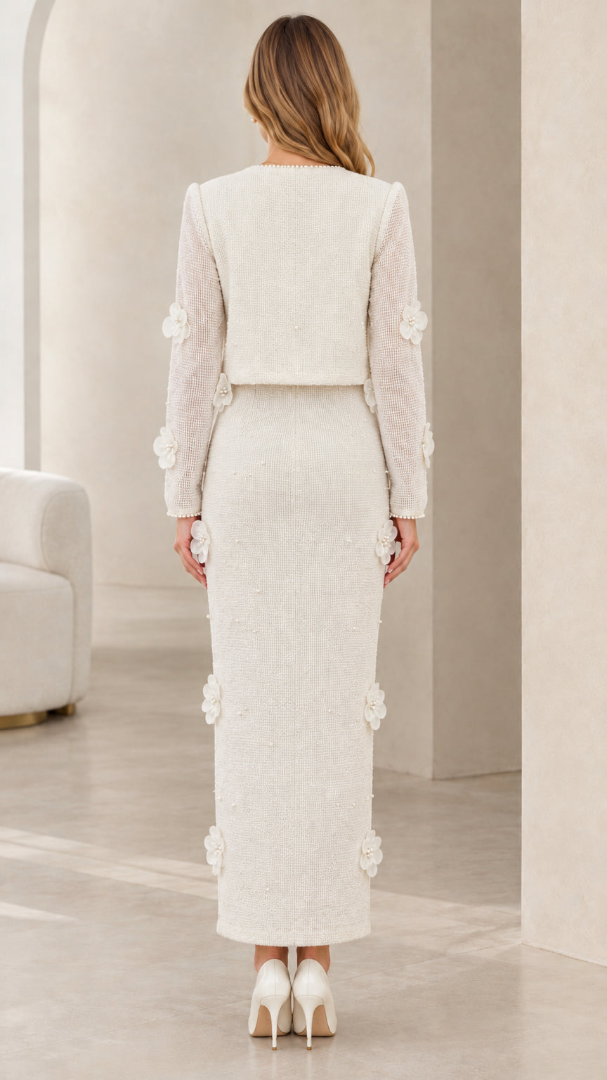 Back view of model wearing ivory tweed cropped jacket and column maxi skirt