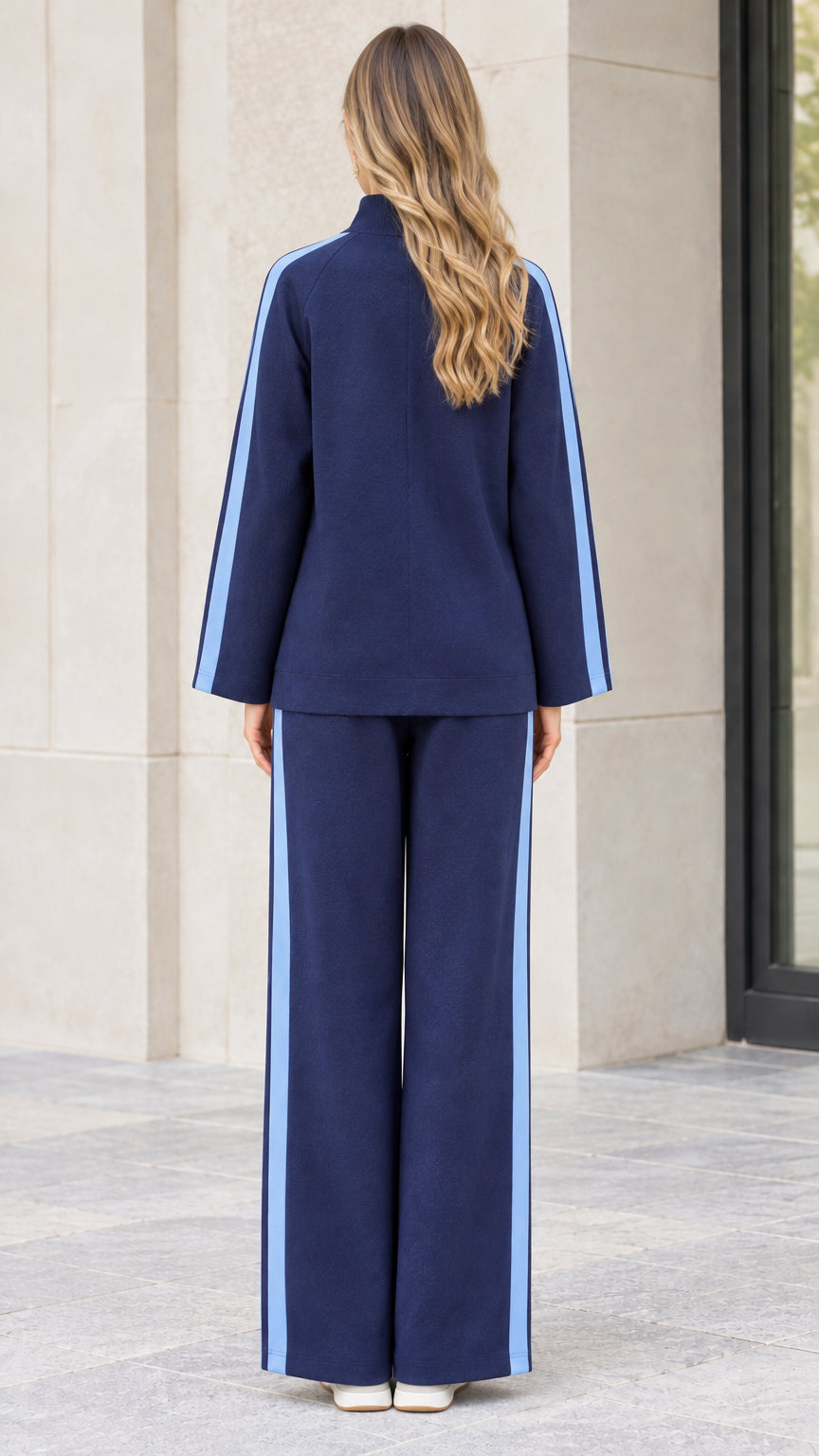 Back full-length view of navy blue two-piece zip-up tracksuit showing straight fit and contrasting side stripes