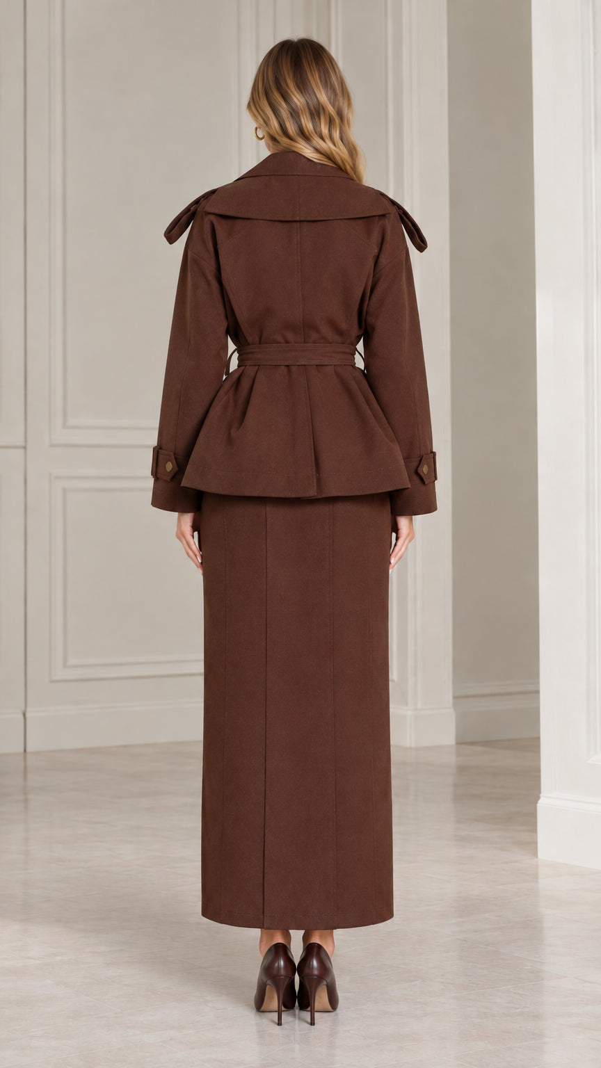 Back view of chocolate brown belted jacket and long skirt suit