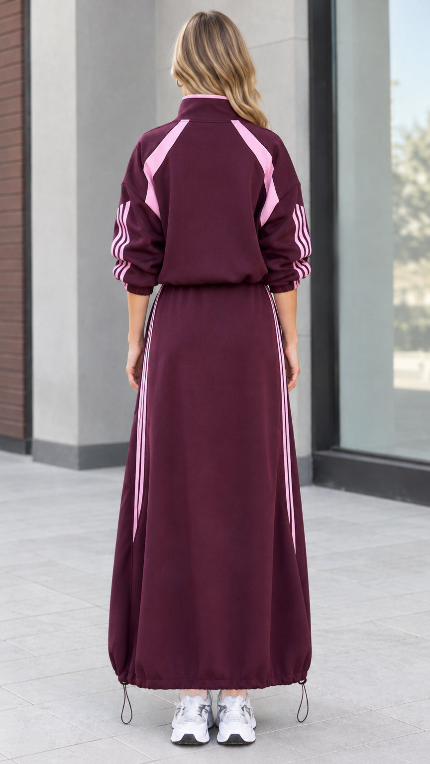 Back view of woman wearing burgundy track jacket and matching maxi skirt set