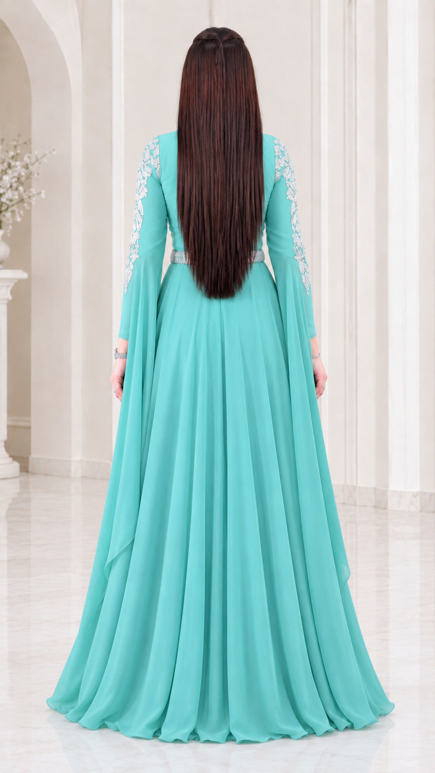Back view of aqua floor-length kaftan dress showing draped cape sleeve detail