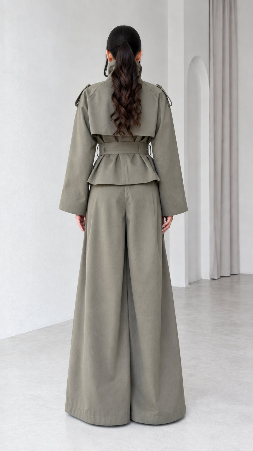 Back view of model in Sage Green trench jacket with storm flap and palazzo pants