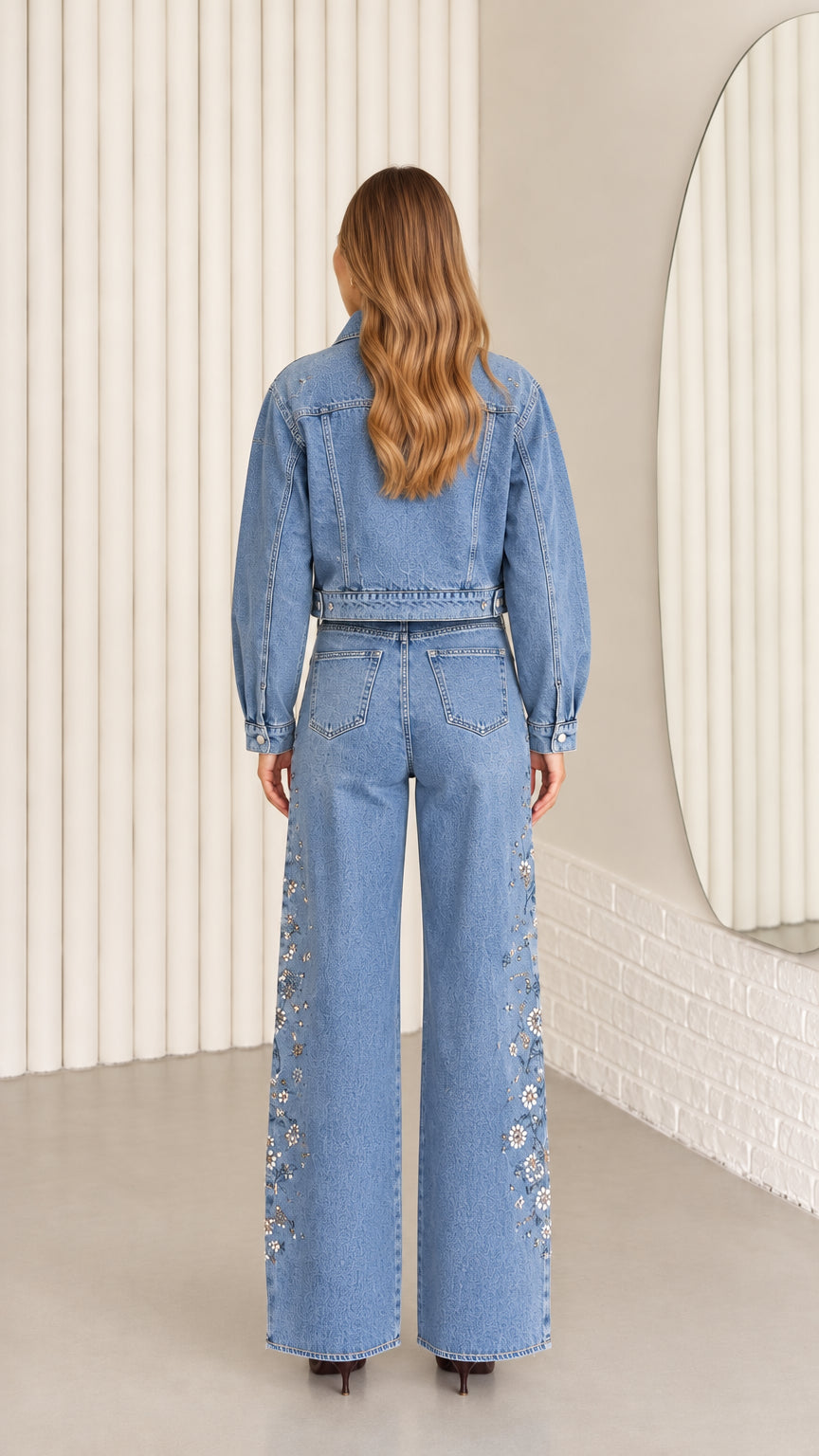 Back view of model wearing Light Blue cropped denim jacket and wide-leg pants