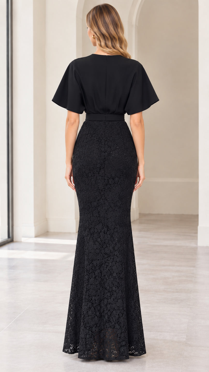 Back full-length view of black flutter sleeve lace maxi gown
