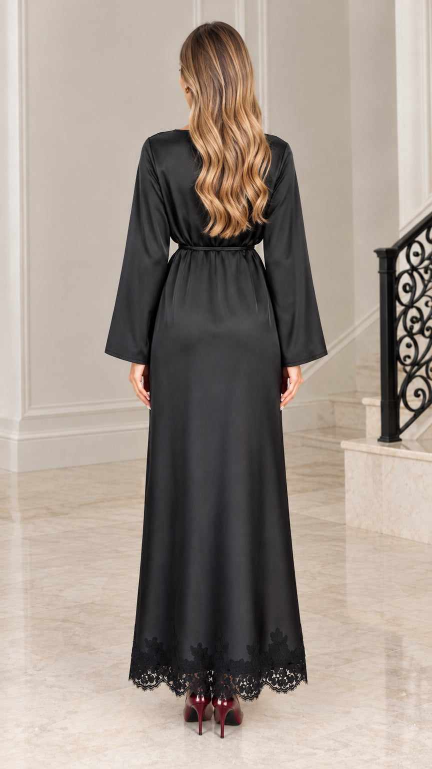 Back full-length view of elegant black satin evening dress