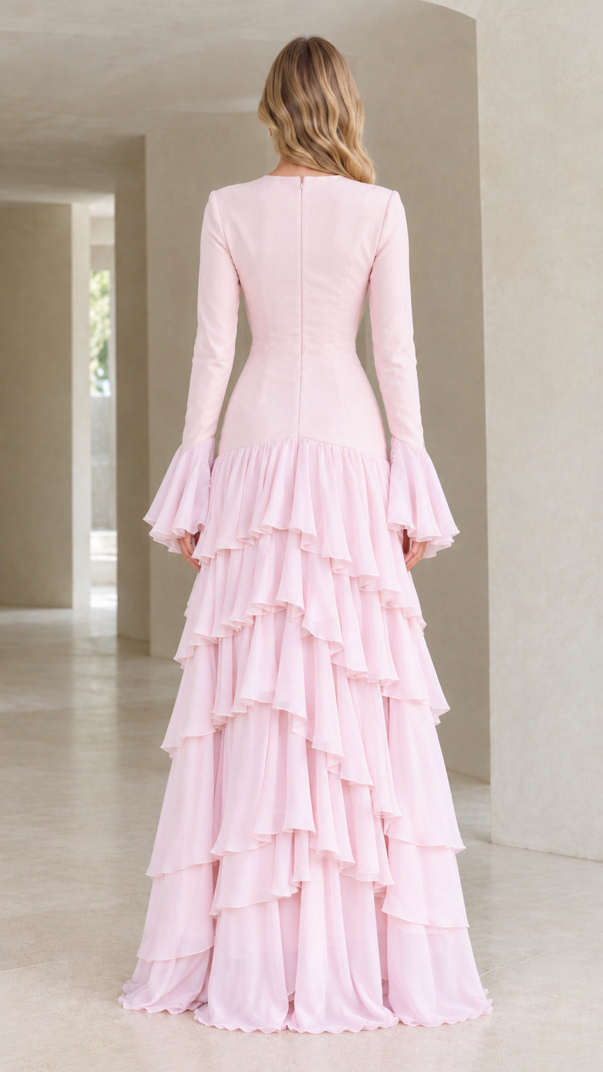 Back view of woman wearing blush pink long sleeve formal evening gown