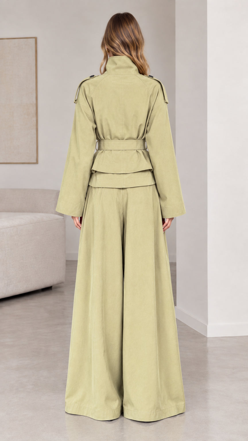 Back view of woman wearing sage green belted trench jacket and wide palazzo pants
