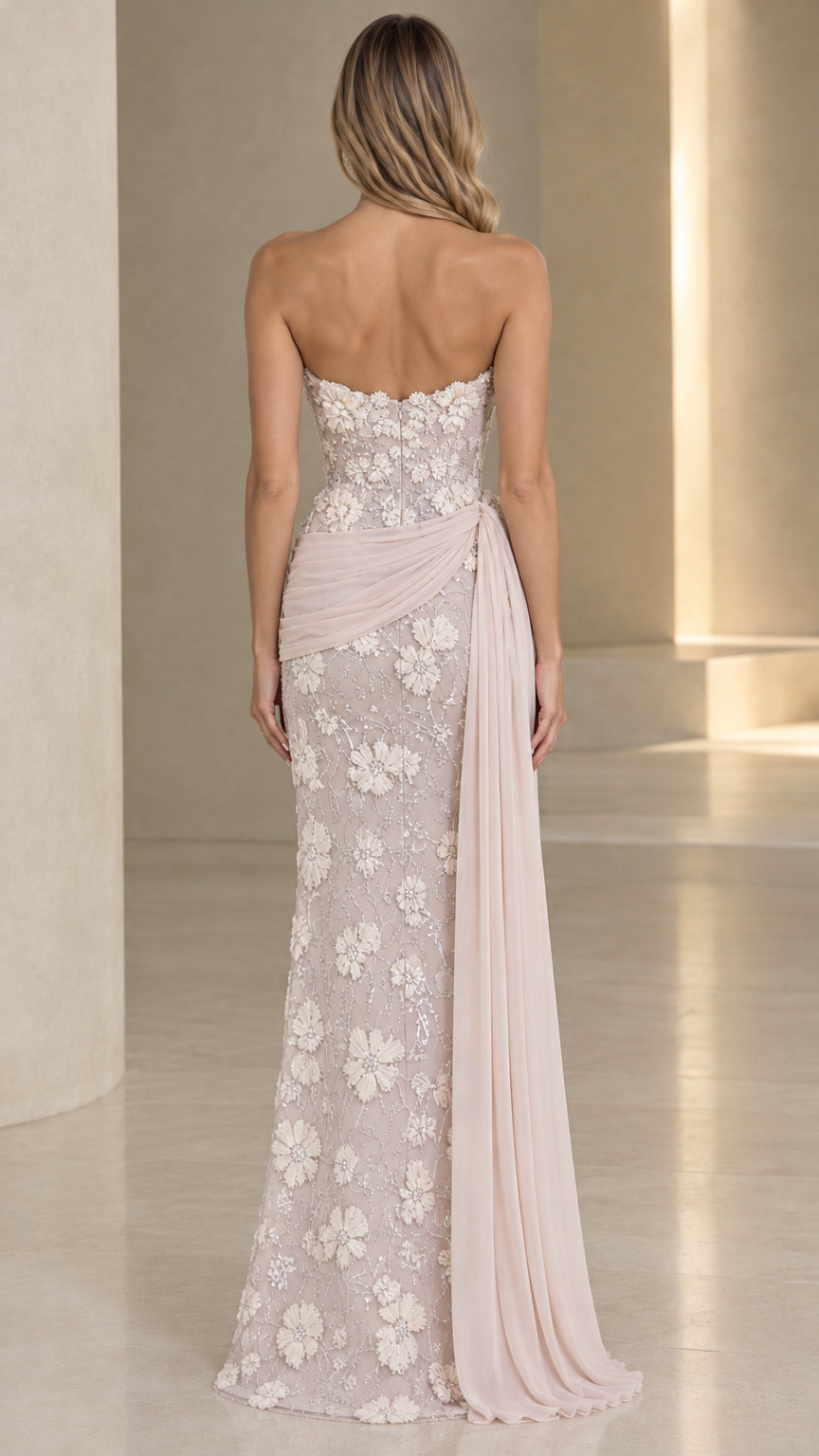 Back view of strapless blush lace evening dress with elegant floor-length drape
