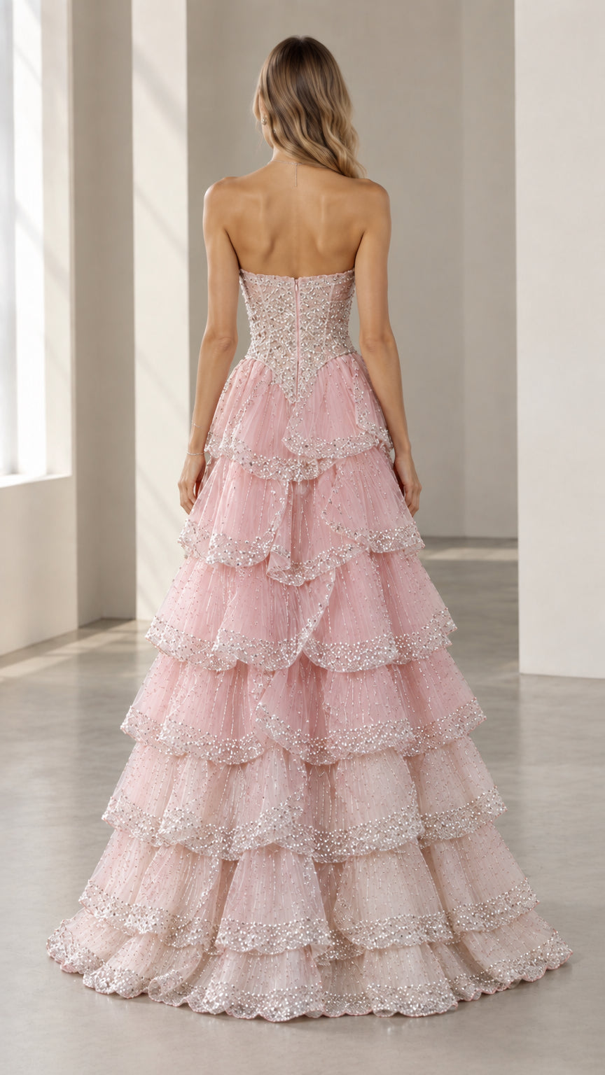 Back full-length view of the Blush Pink tiered tulle evening gown