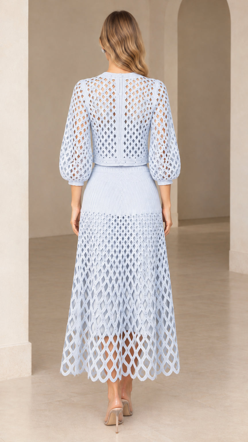 Back view of model in sky blue openwork knit skirt set