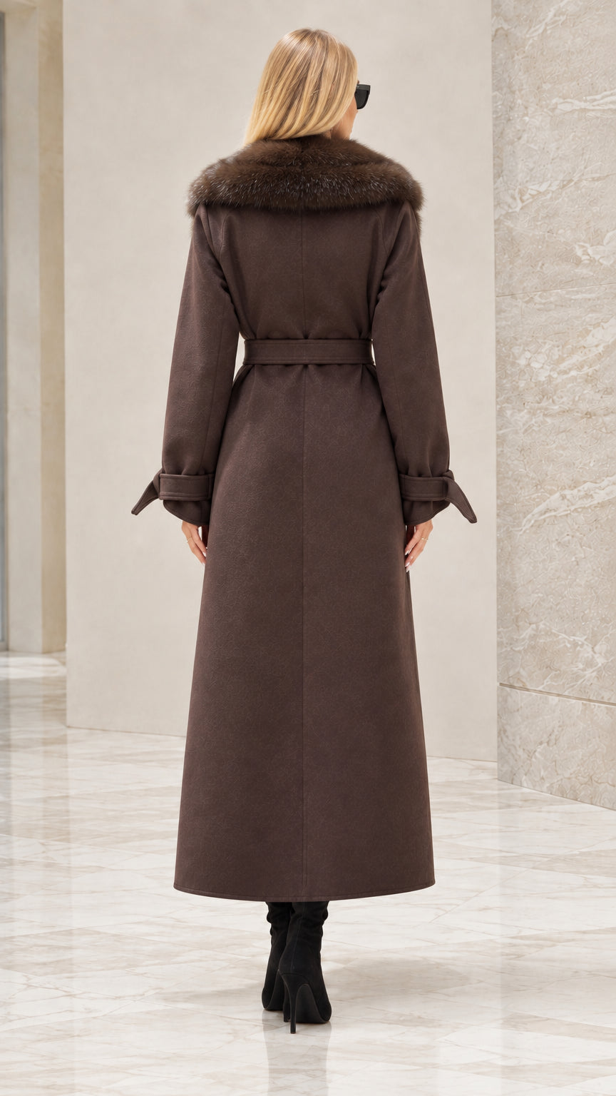 Back view of woman wearing brown maxi trench coat with waist tie