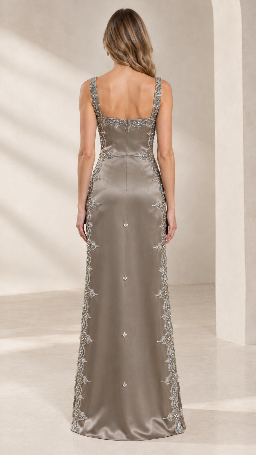 Back view of model in taupe satin column gown with square back neckline