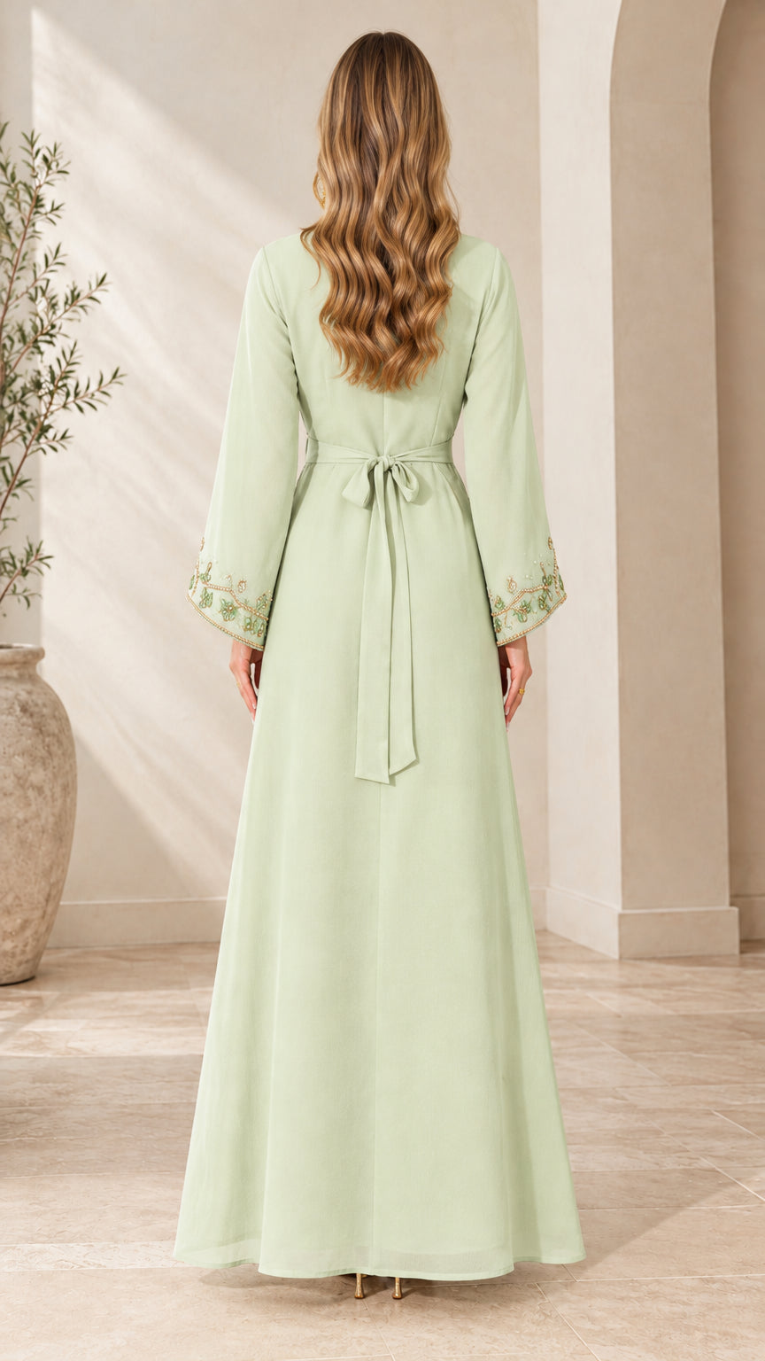 Back view of woman wearing Mint Green maxi dress showcasing waist tie belt