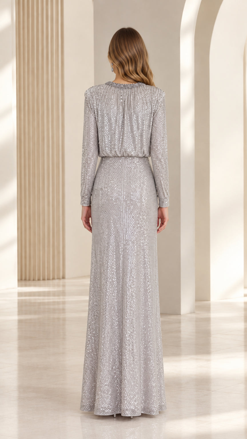 Back view of the silver sequin evening gown highlighting the blouson bodice and long skirt