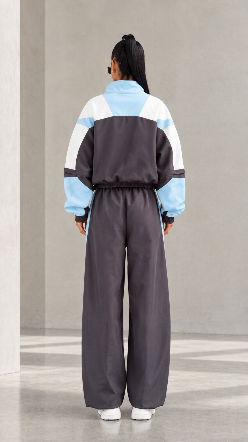 Model wearing Charcoal Grey colorblock tracksuit set back view
