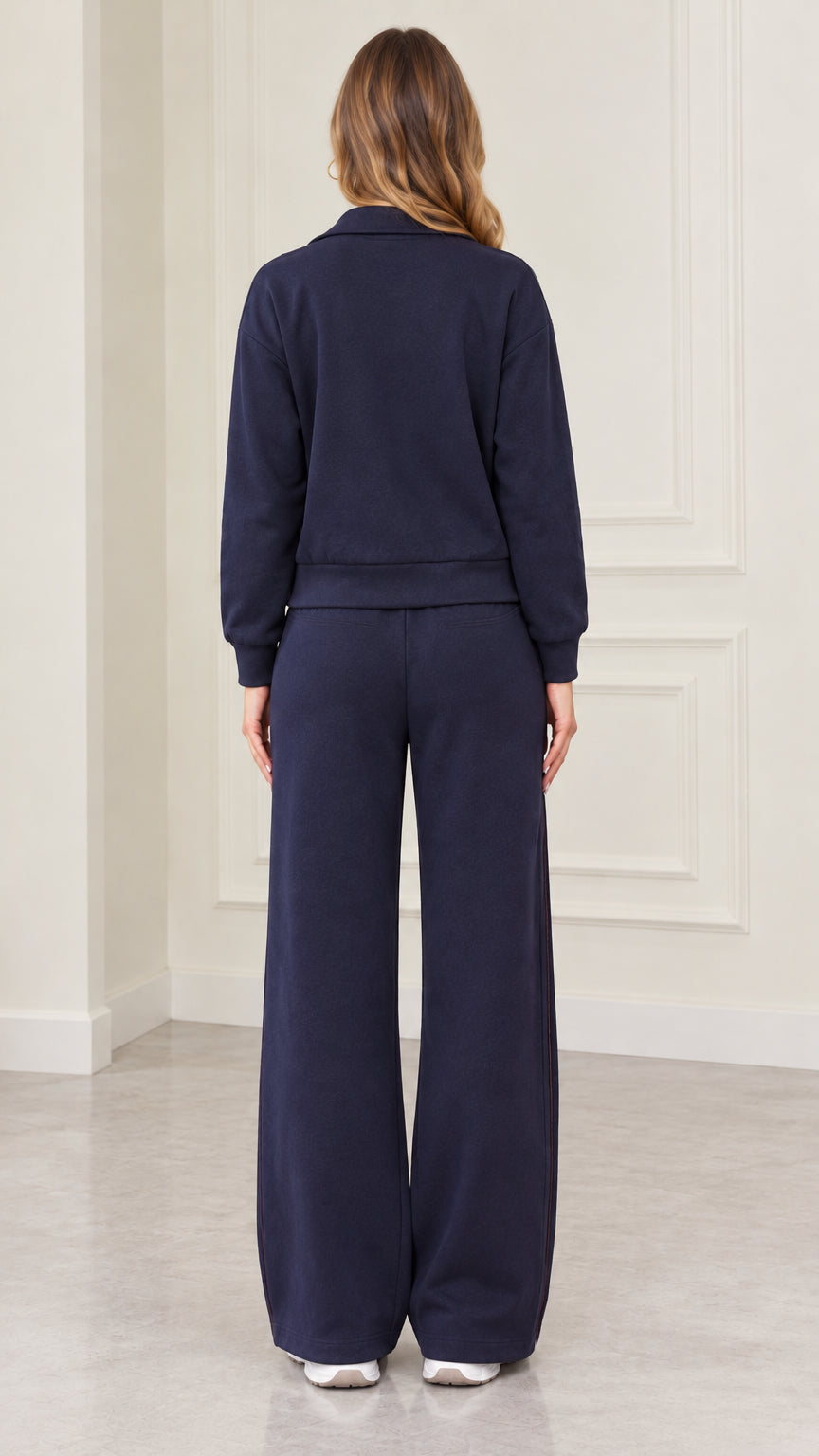 Back view of model wearing Navy Blue matching jacket and wide-leg track pants