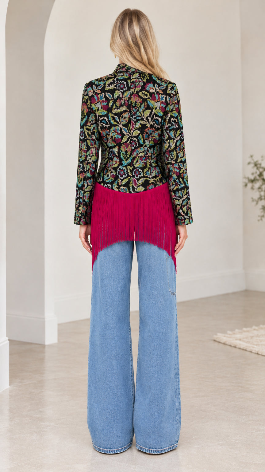 Back view of model highlighting the structured back and cascading hemline fringe