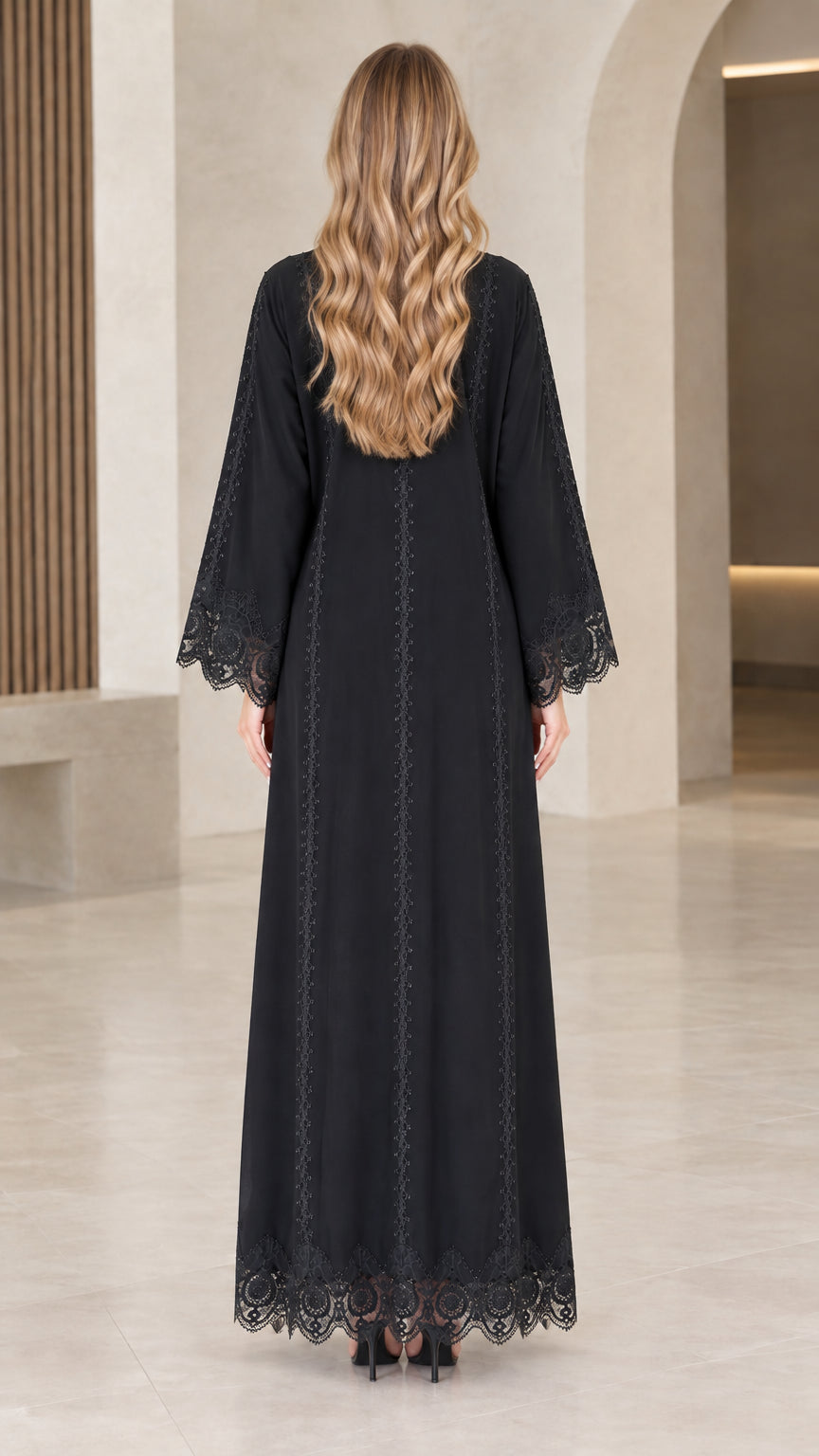 Back view of woman wearing black long sleeve abaya dress showing lace paneling