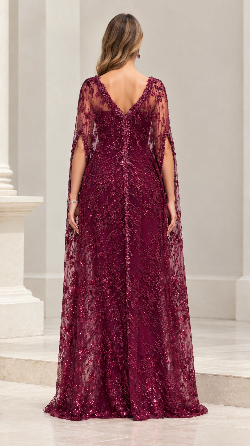 Back view of burgundy embroidered cape gown showing drape