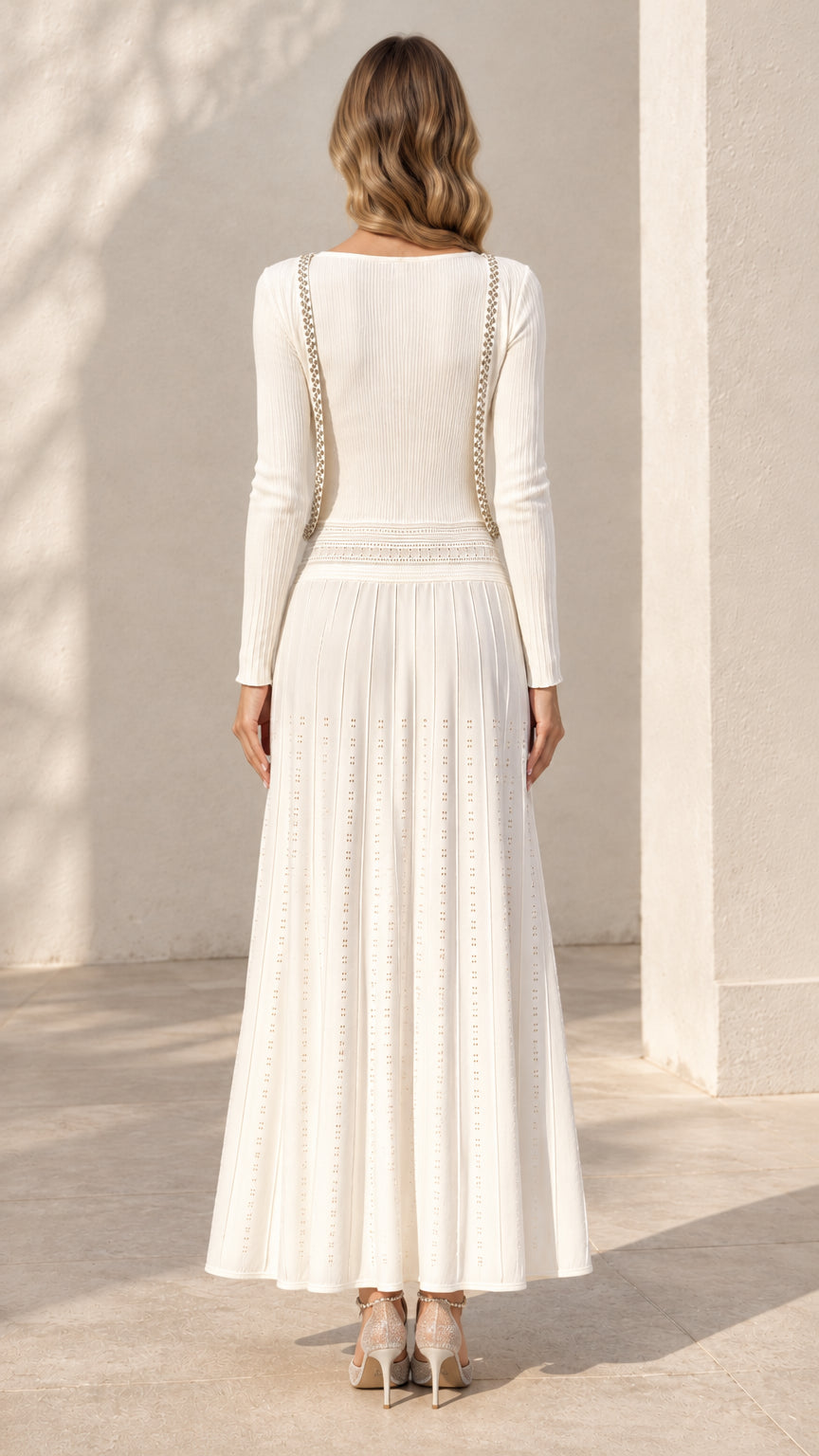 Back view of model wearing ivory white ribbed knit dress set showing silhouette