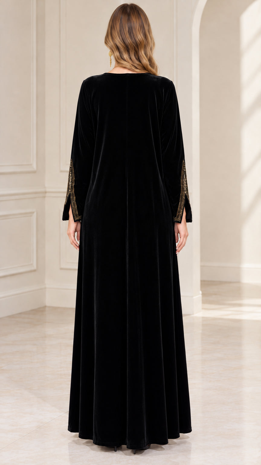 Back view of woman wearing black floor-length velvet maxi dress