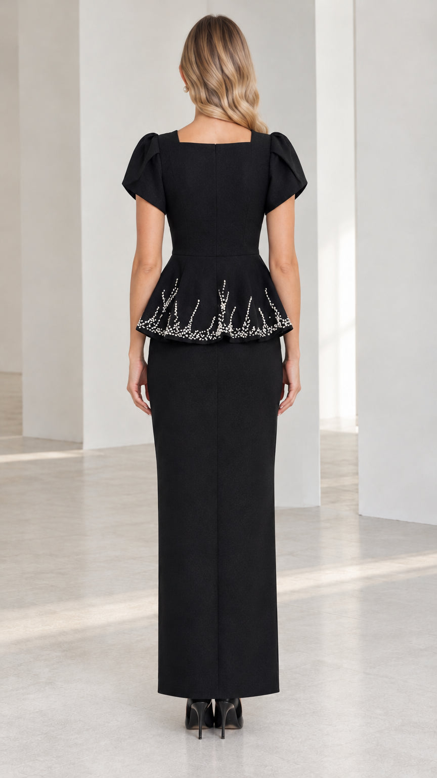 Back view of model wearing black square back peplum maxi dress