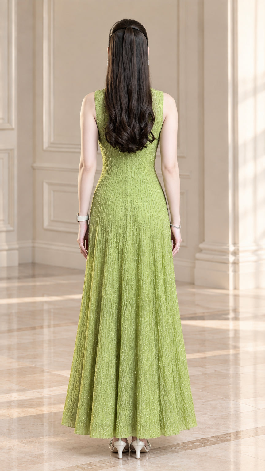 Back view of model wearing light green sleeveless textured plissé maxi dress with concealed zipper
