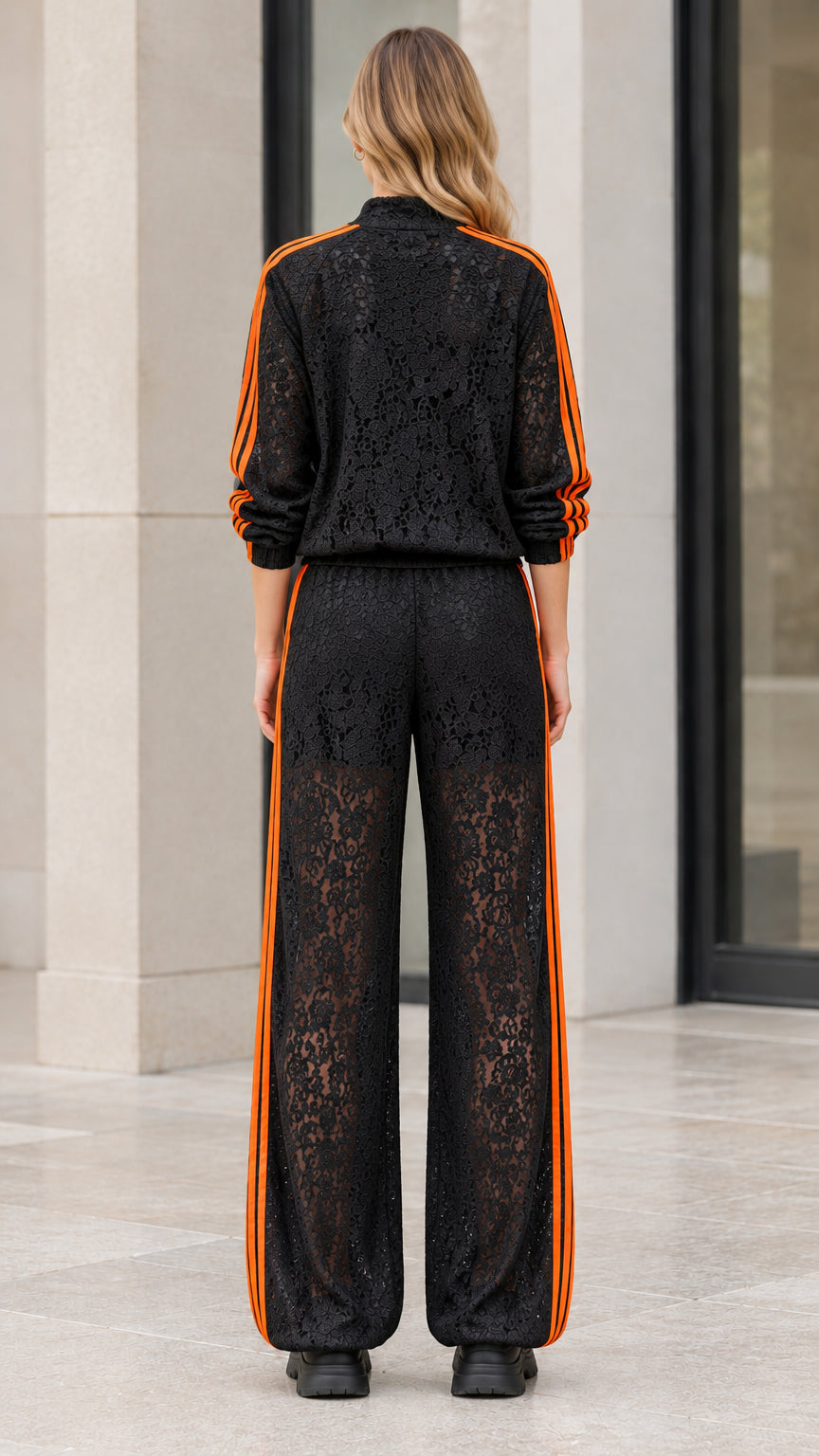 Back view of woman wearing black floral lace jacket and matching wide leg pants