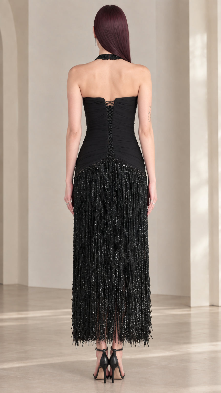 Back view of black halter open back fringe evening dress