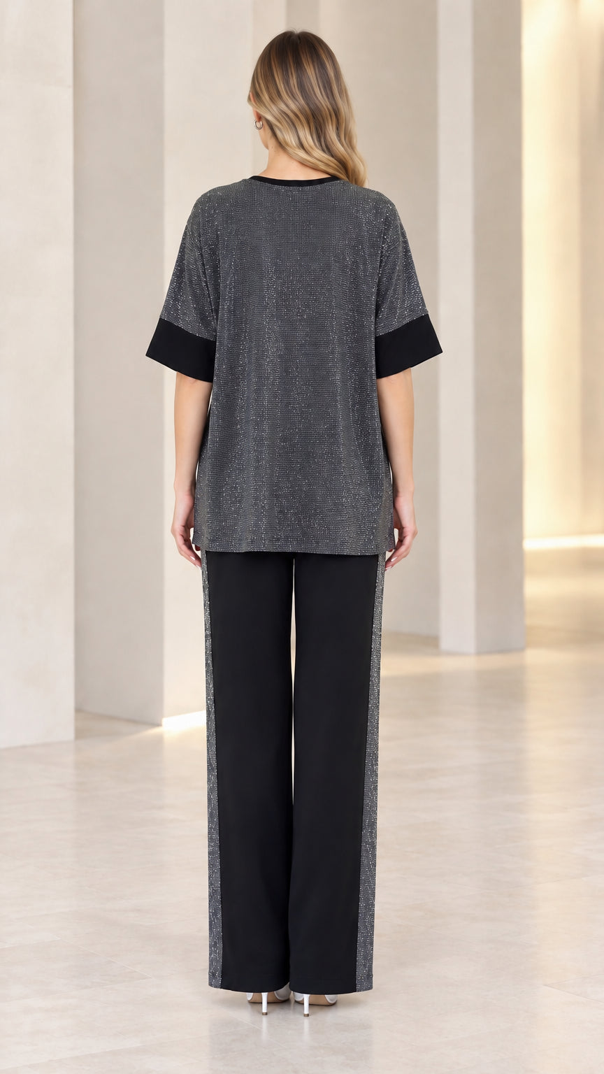Back full-length view of model wearing charcoal shimmer two-piece set