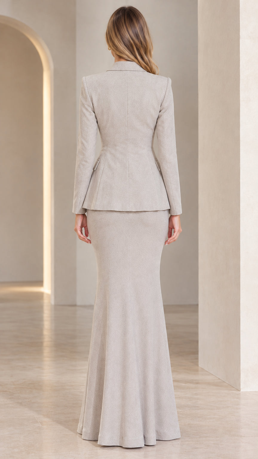Back view of model in Light Grey long fishtail skirt and tailored blazer set