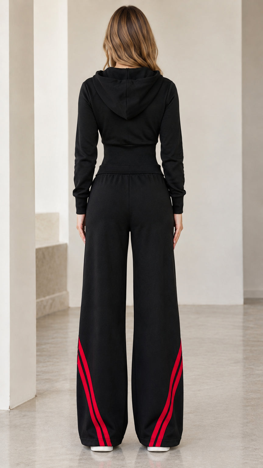 Back view of women's black hooded tracksuit set showing hood and wide trousers silhouette
